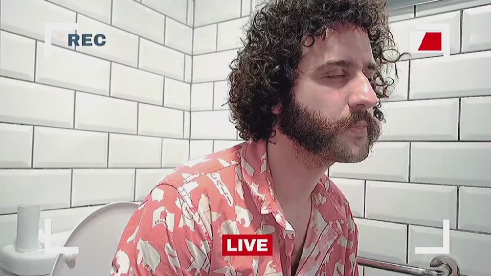 Disappointed man sitting on toilet