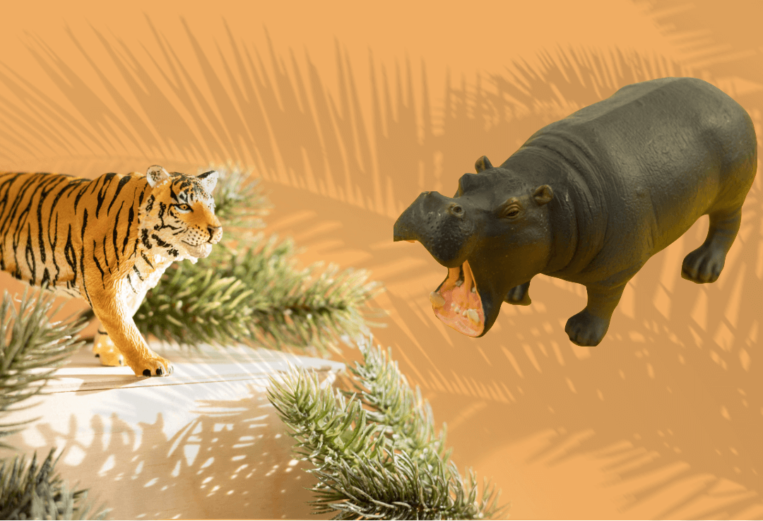 Tiger and hippo toy models with palm background