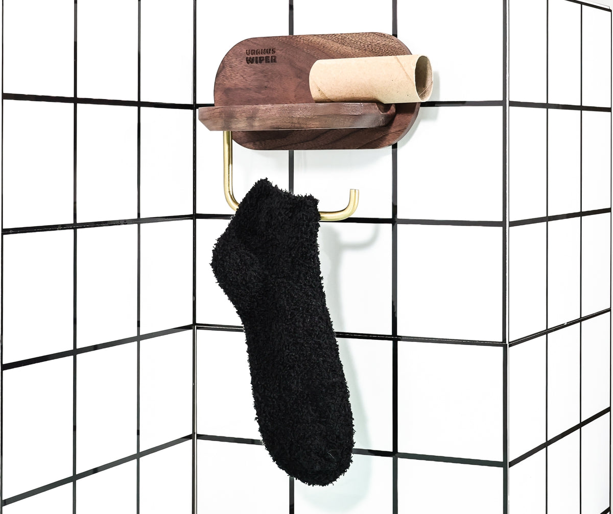Black socks on empty toilet roll holder