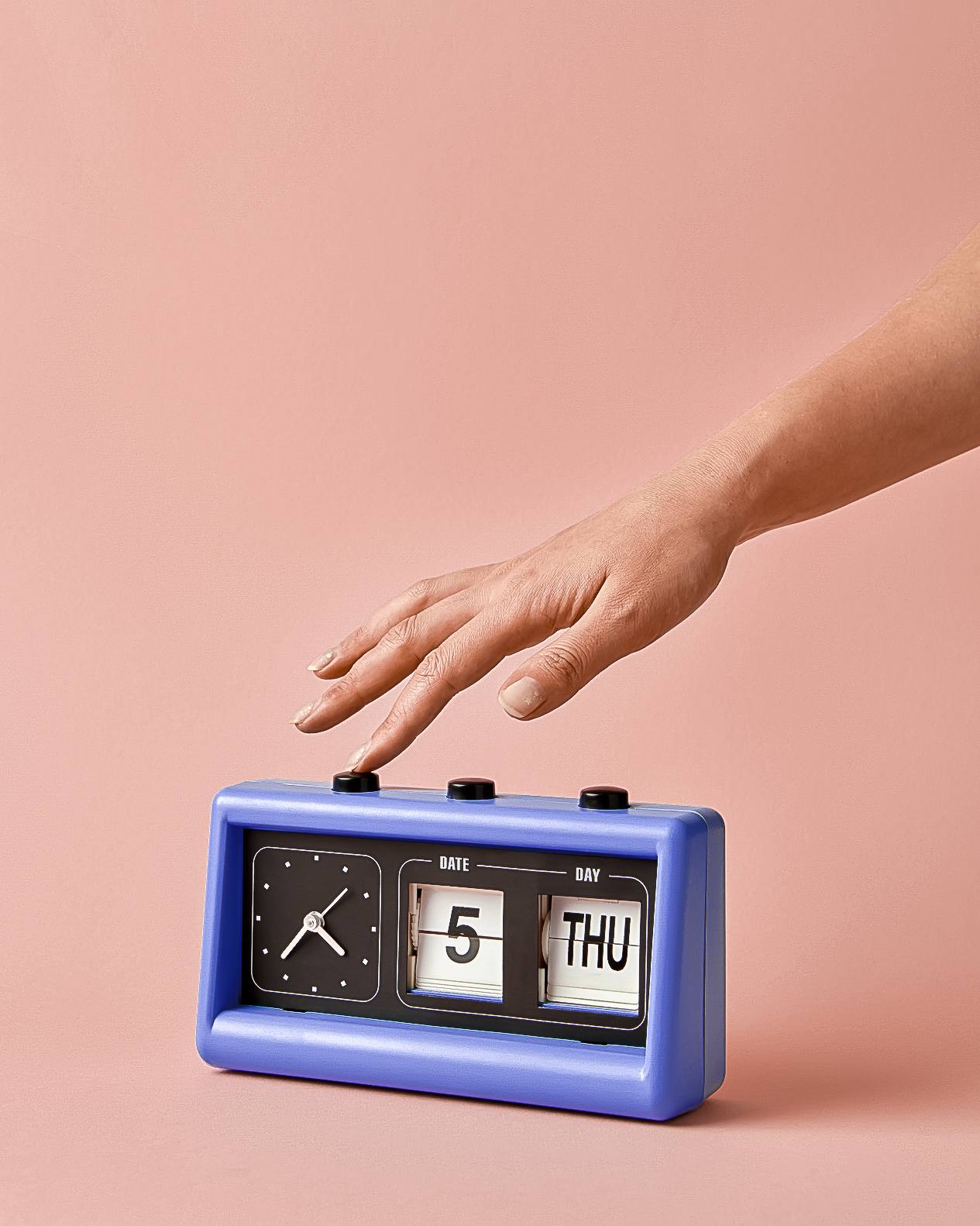 Woman's hand turns off the button on retro flip clock